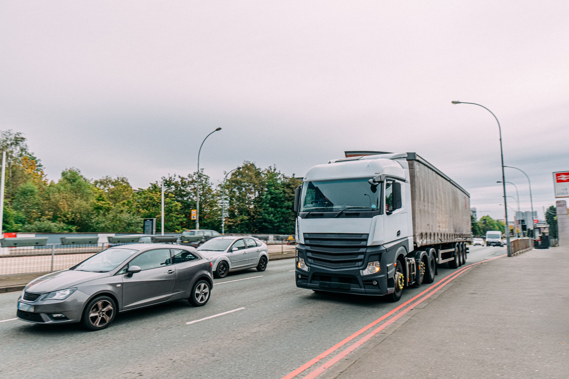 Cabover-Style Semi Truck Driving Delivering Goods in Birmingham, UK